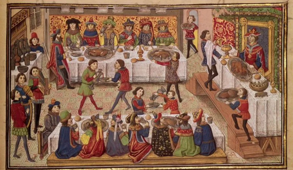 people in medieval clothing at a feast